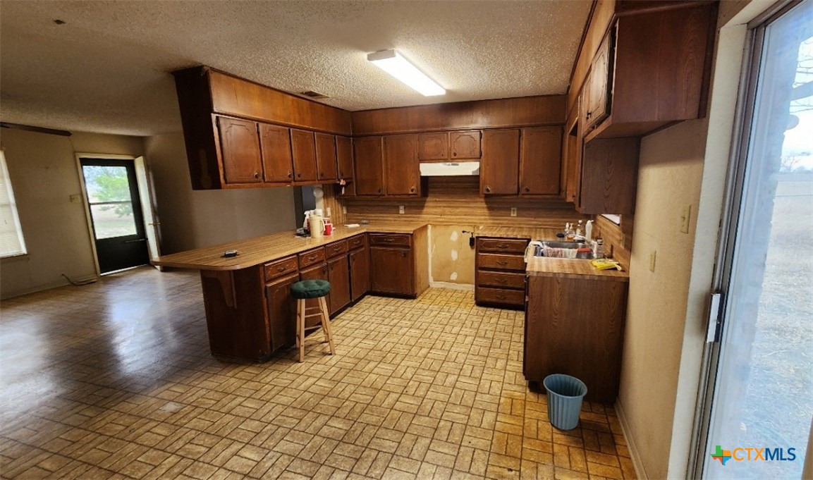 2002 Airville Road Temple, TX 76501 - Photo 16 of 41 a kitchen with granite countertop a sink stove and cabinets