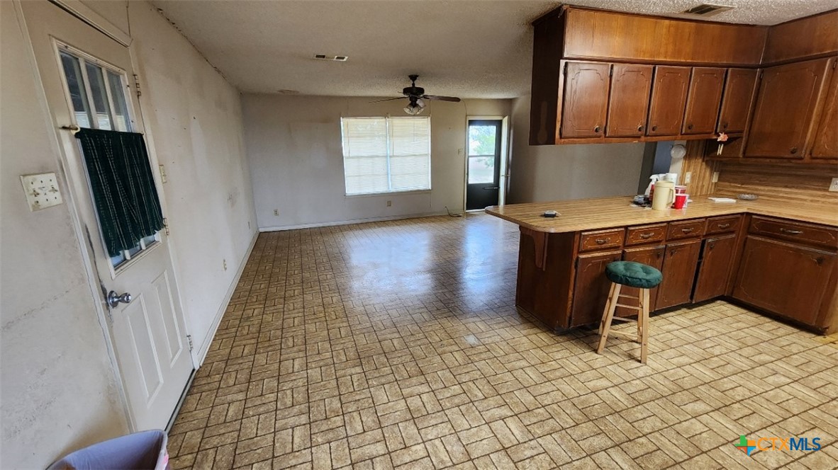 2002 Airville Road Temple, TX 76501 - Photo 17 of 41 a kitchen with kitchen island granite countertop a sink stove and refrigerator
