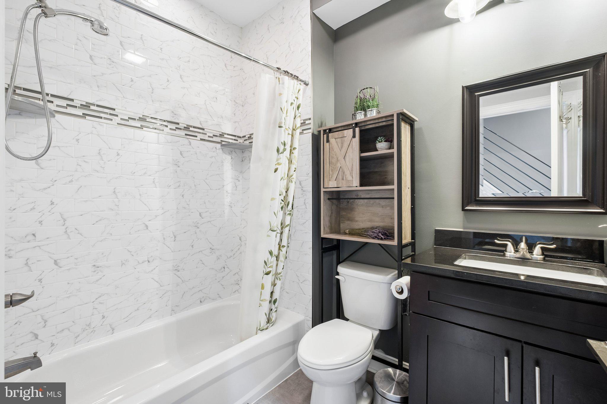 3356 Agate Street Philadelphia, PA 19134 - Photo 16 of 31 a bathroom with a granite countertop sink toilet and shower