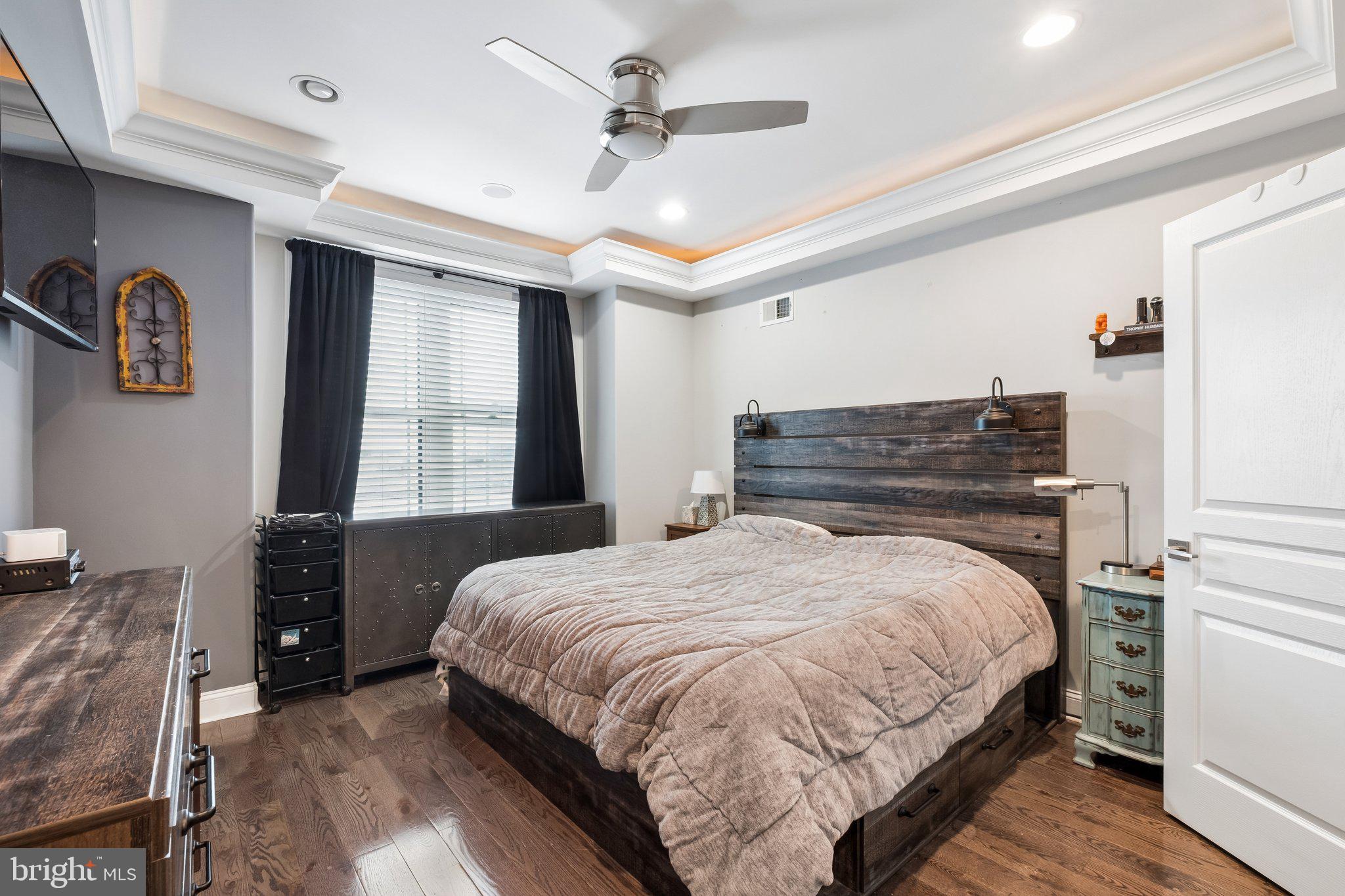 3356 Agate Street Philadelphia, PA 19134 - Photo 24 of 31 a bedroom with a large bed chandelier and a window