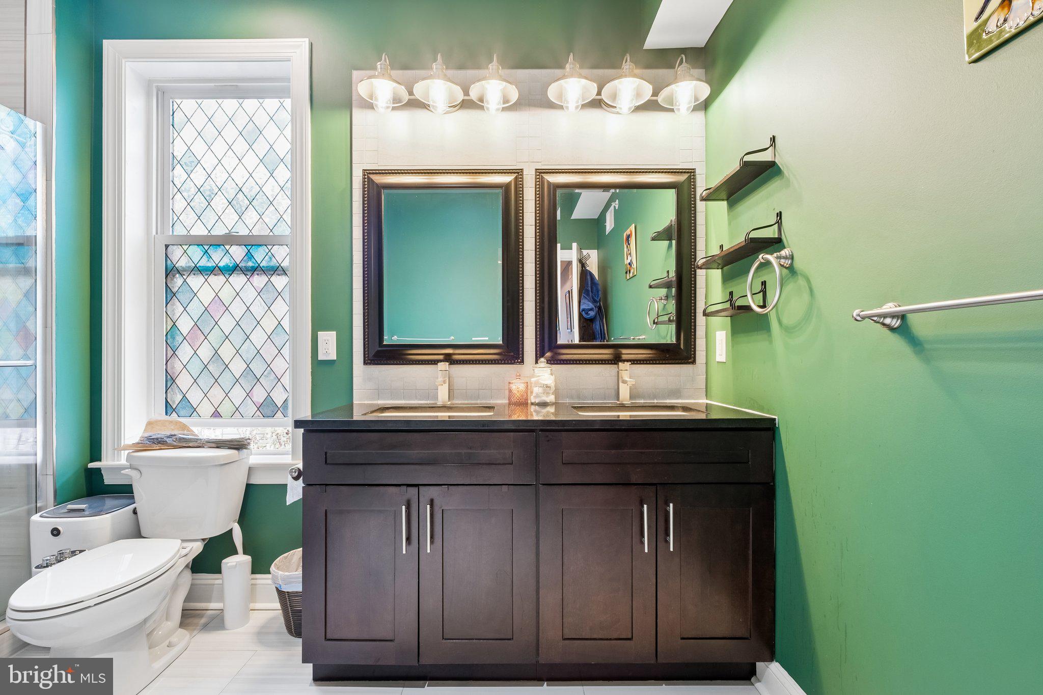 3356 Agate Street Philadelphia, PA 19134 - Photo 26 of 31 a bathroom with a granite countertop sink a toilet and mirror