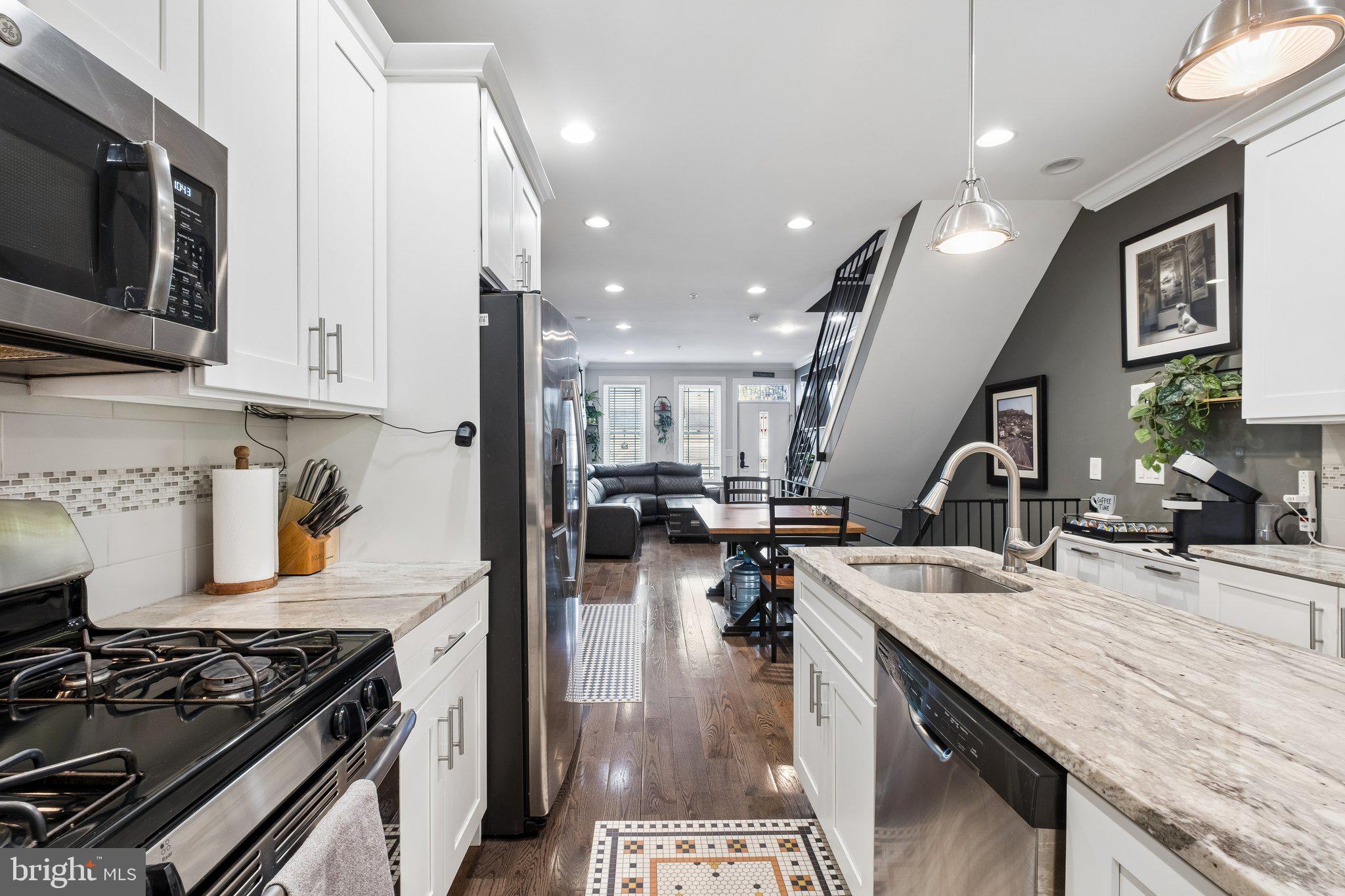 3356 Agate Street Philadelphia, PA 19134 - Photo 9 of 31 a kitchen with a stove a sink and a microwave