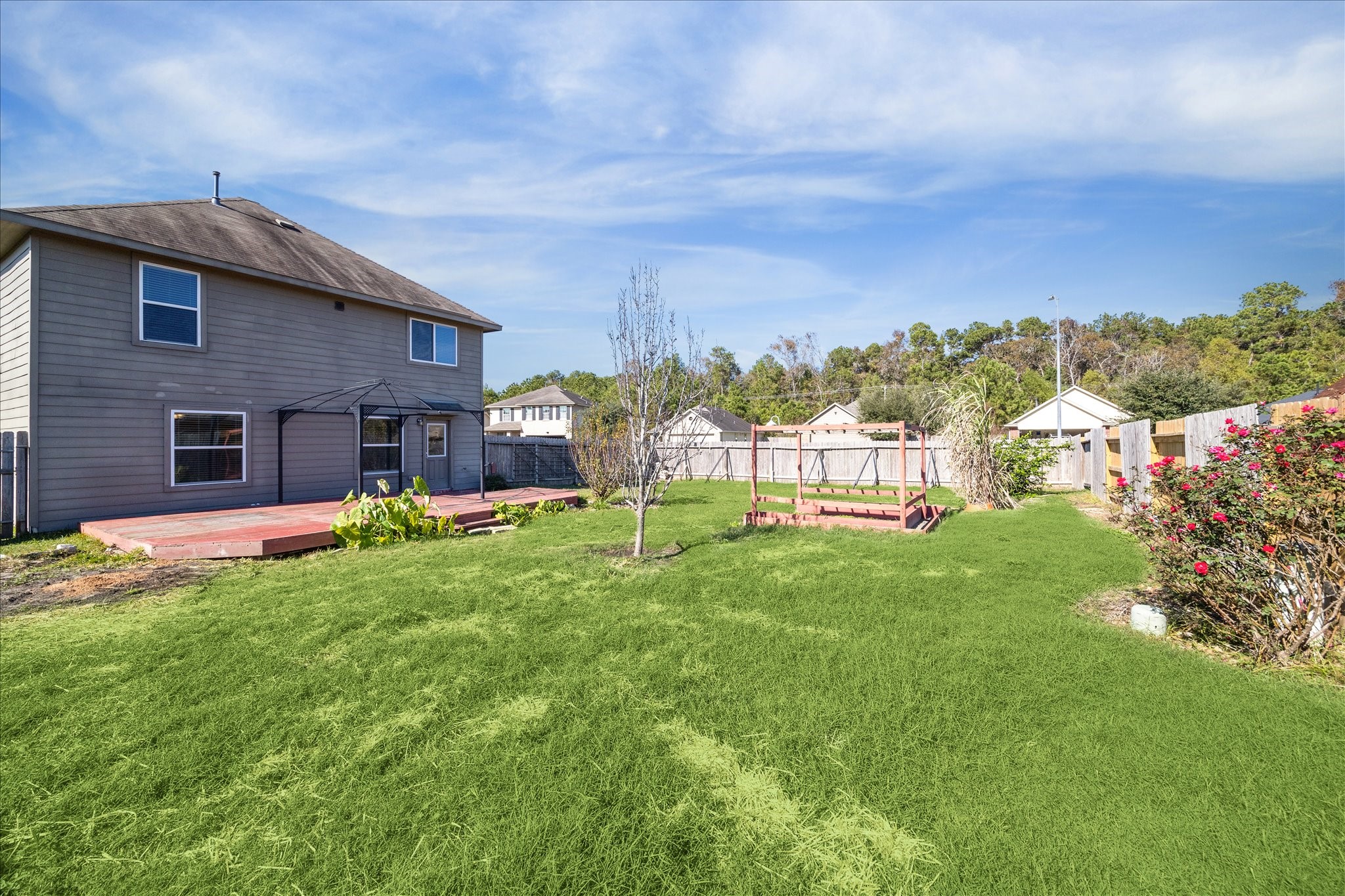 5710 Mid Way Kingwood, TX 77339 - Photo 15 of 15 a view of a house with a yard