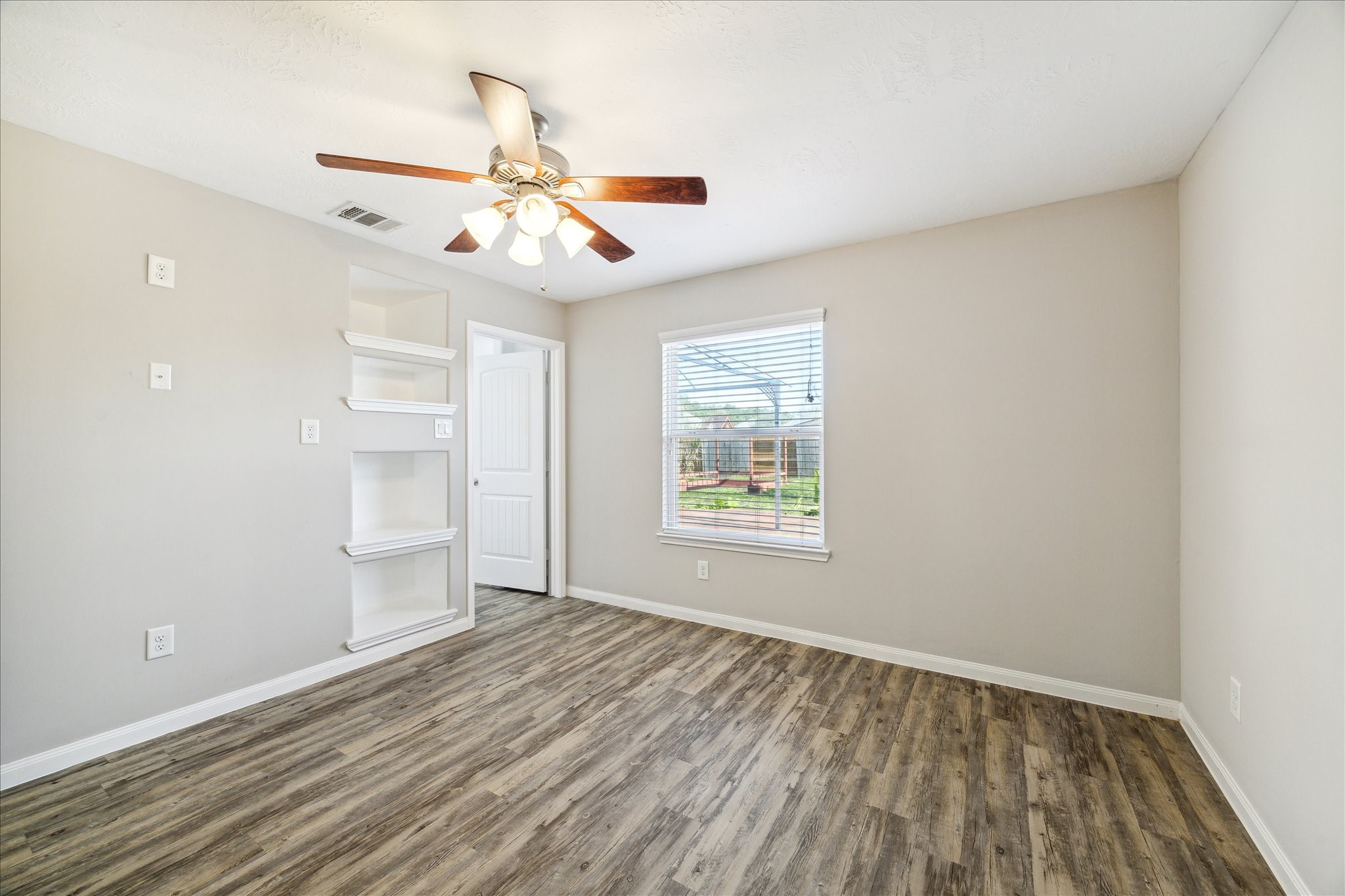 5710 Mid Way Kingwood, TX 77339 - Photo 7 of 15 wooden floor in an empty room with a window