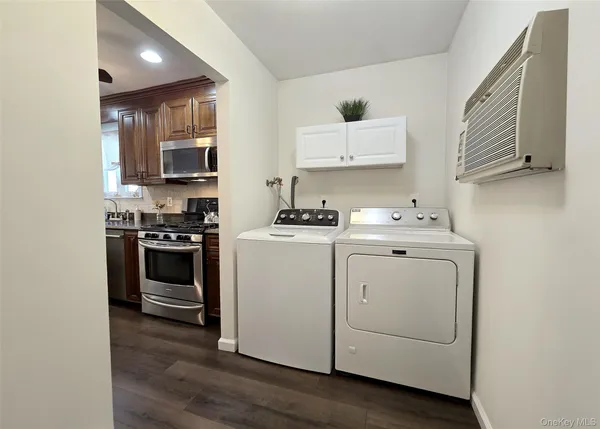 a kitchen with cabinets and steel appliances