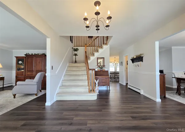 a view of entryway and hall with wooden floor