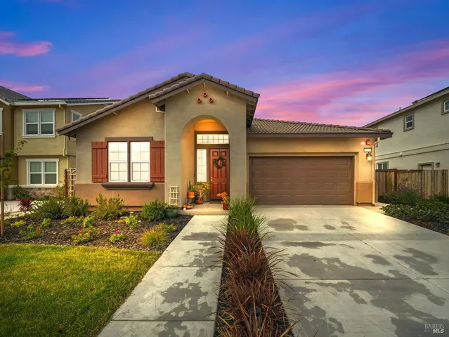 a aerial view of a house with swimming pool and large trees