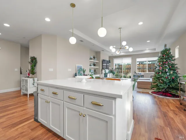 a view of living room kitchen with furniture and wooden floor