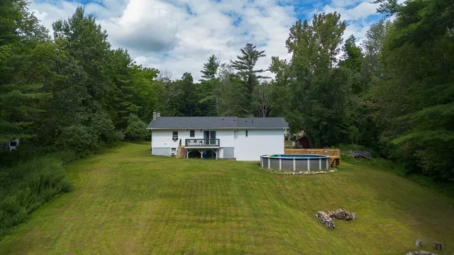 a house with a table & chairs in a lake