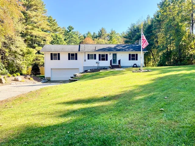 a view of a house with swimming pool and a yard