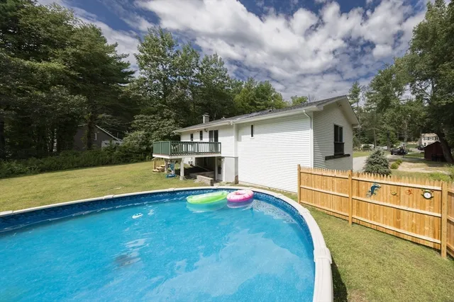 a view of a backyard with swimming pool