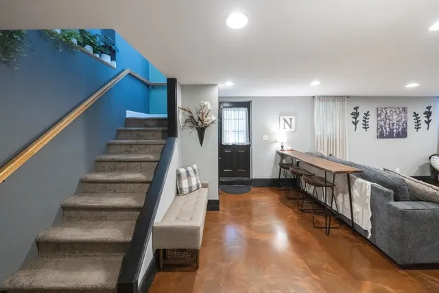 a view of entryway and hall with wooden floor