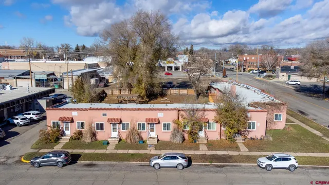 a view of a cars park in front of a building