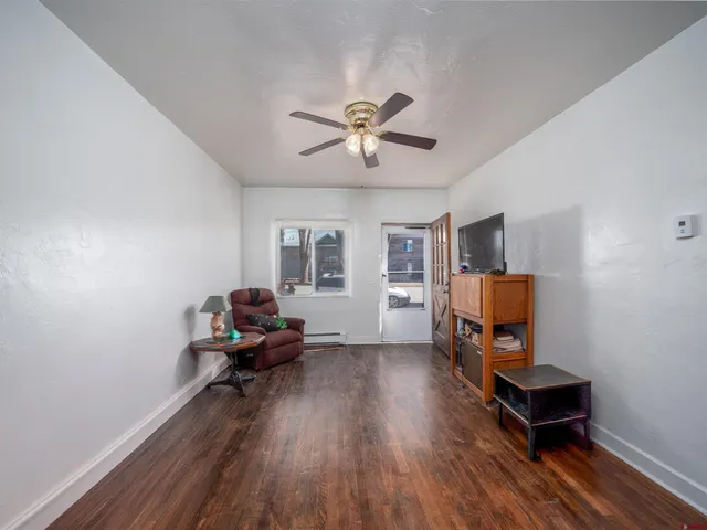 a living room with furniture and a wooden floor