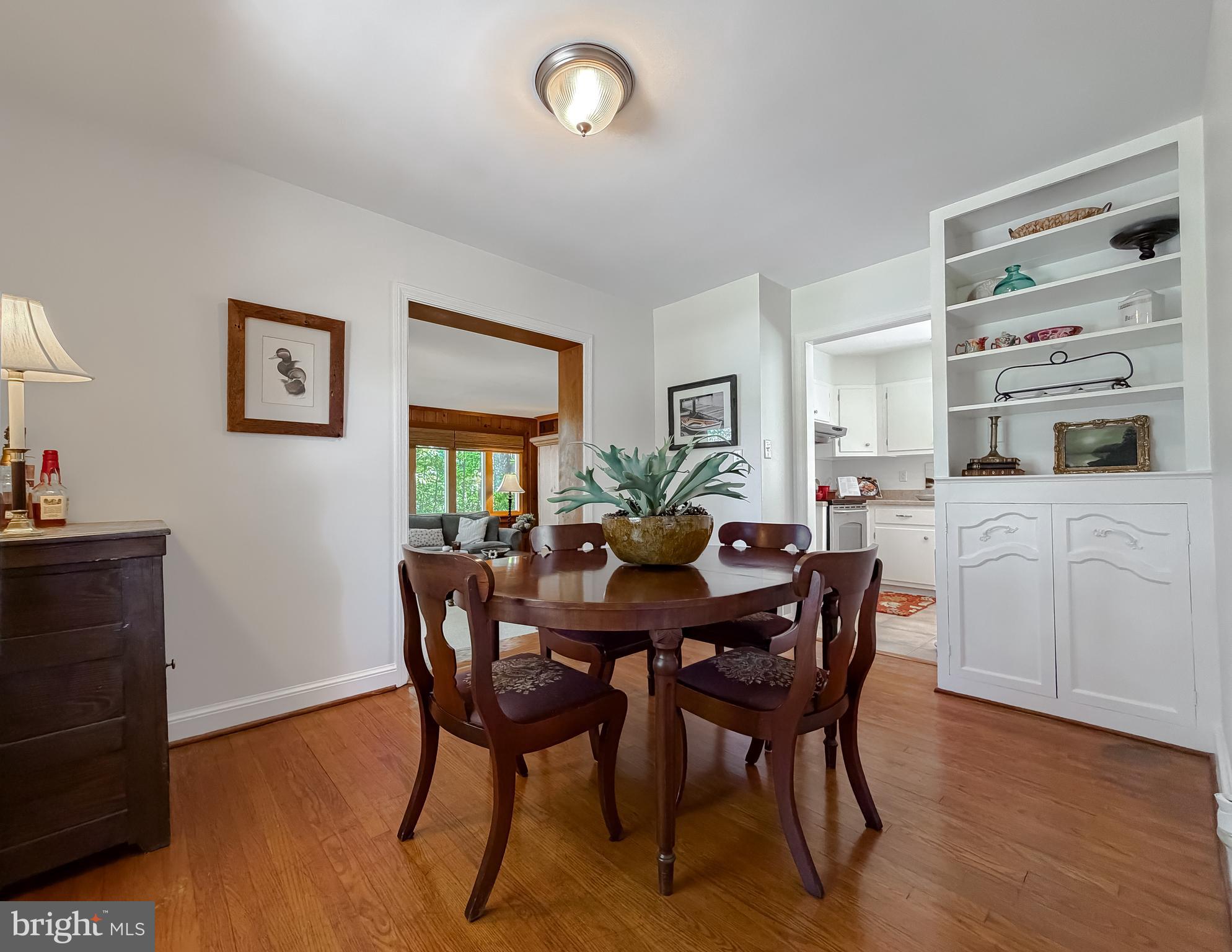 23761 Kingston Creek Road California, MD 20619 - Photo 22 of 61 a view of a dining room with furniture and wooden floor