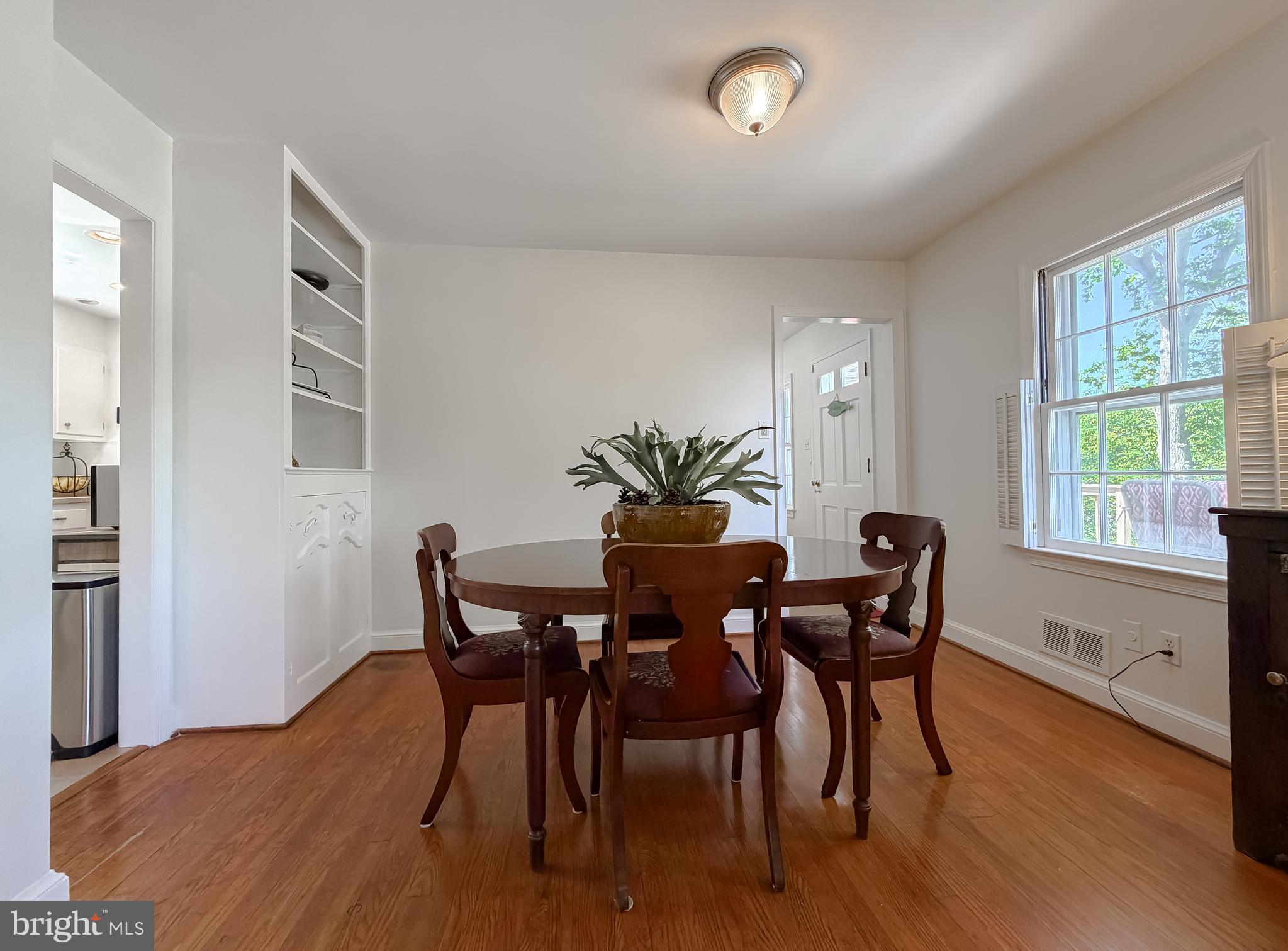 23761 Kingston Creek Road California, MD 20619 - Photo 23 of 61 a view of a dining room with furniture and wooden floor