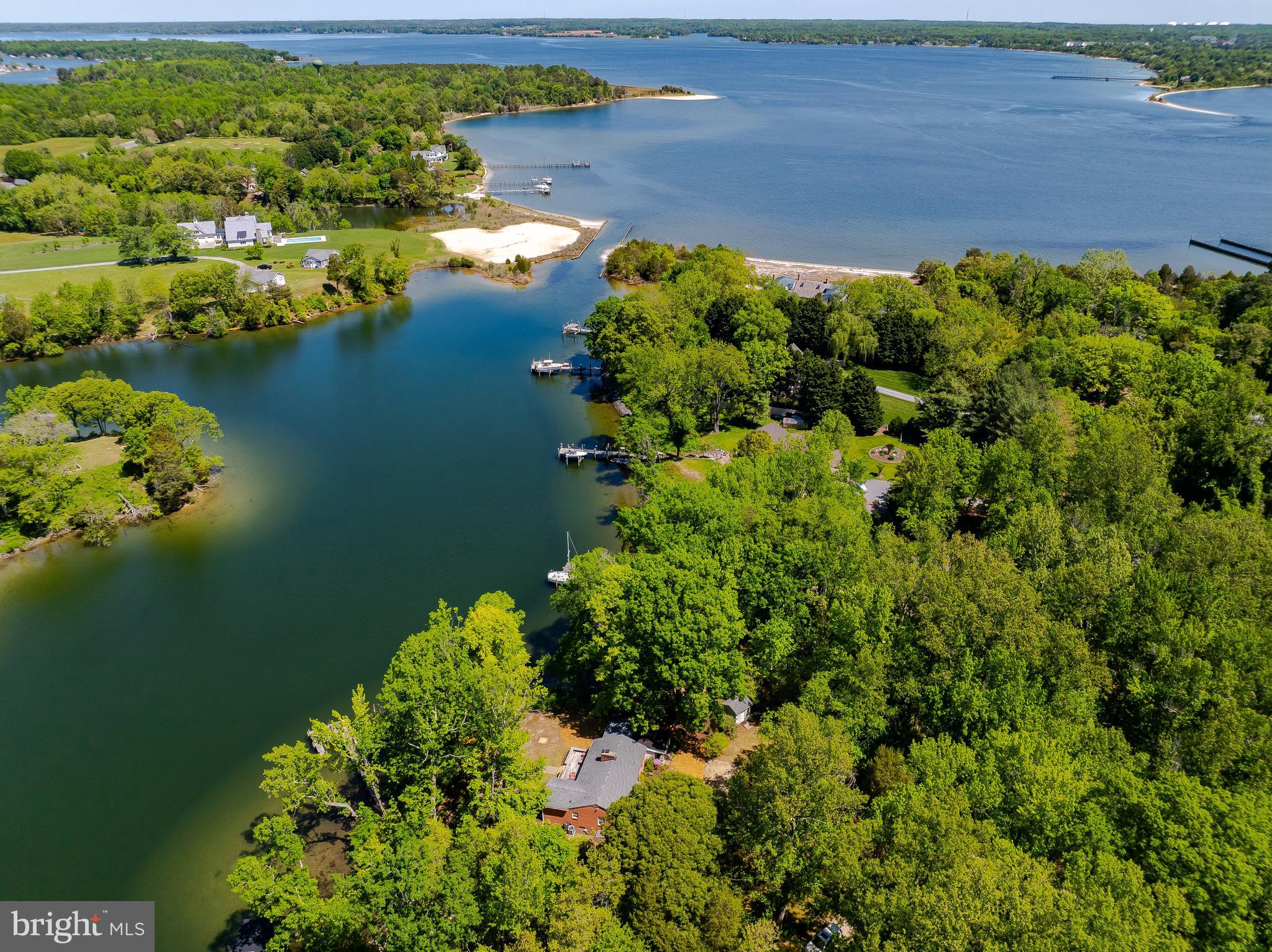 23761 Kingston Creek Road California, MD 20619 - Photo 49 of 61 a view of a lake with lawn chairs
