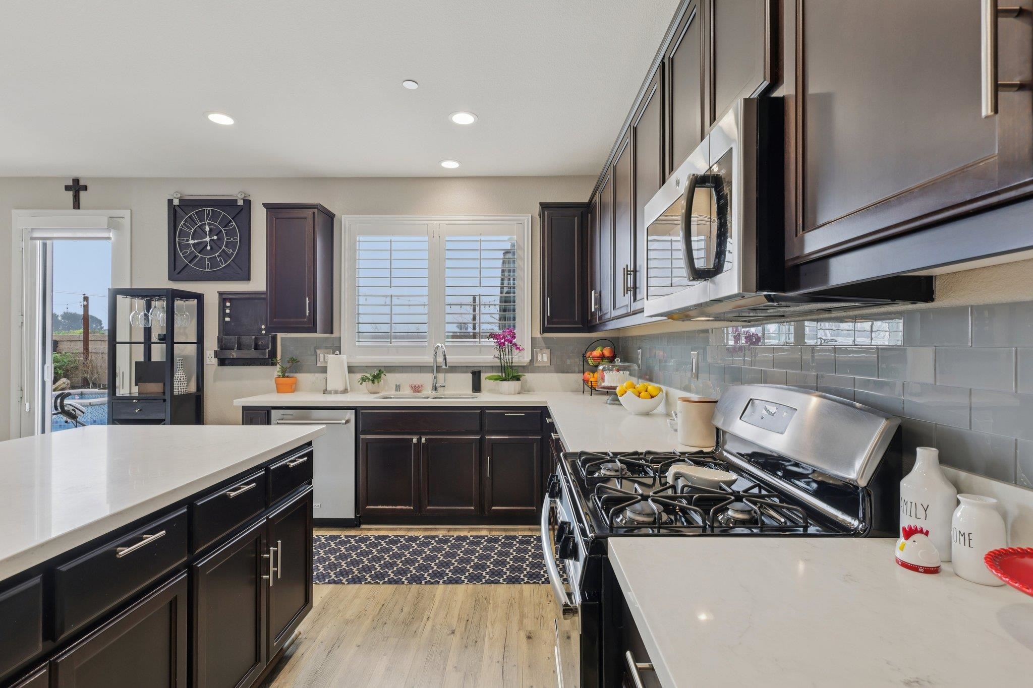 165 Little Ranch Circle Oakley, CA 94561 - Photo 19 of 60 Kitchen featuring stainless steel appliances, recessed lighting, light wood-style flooring, backsplash, and light stone countertops