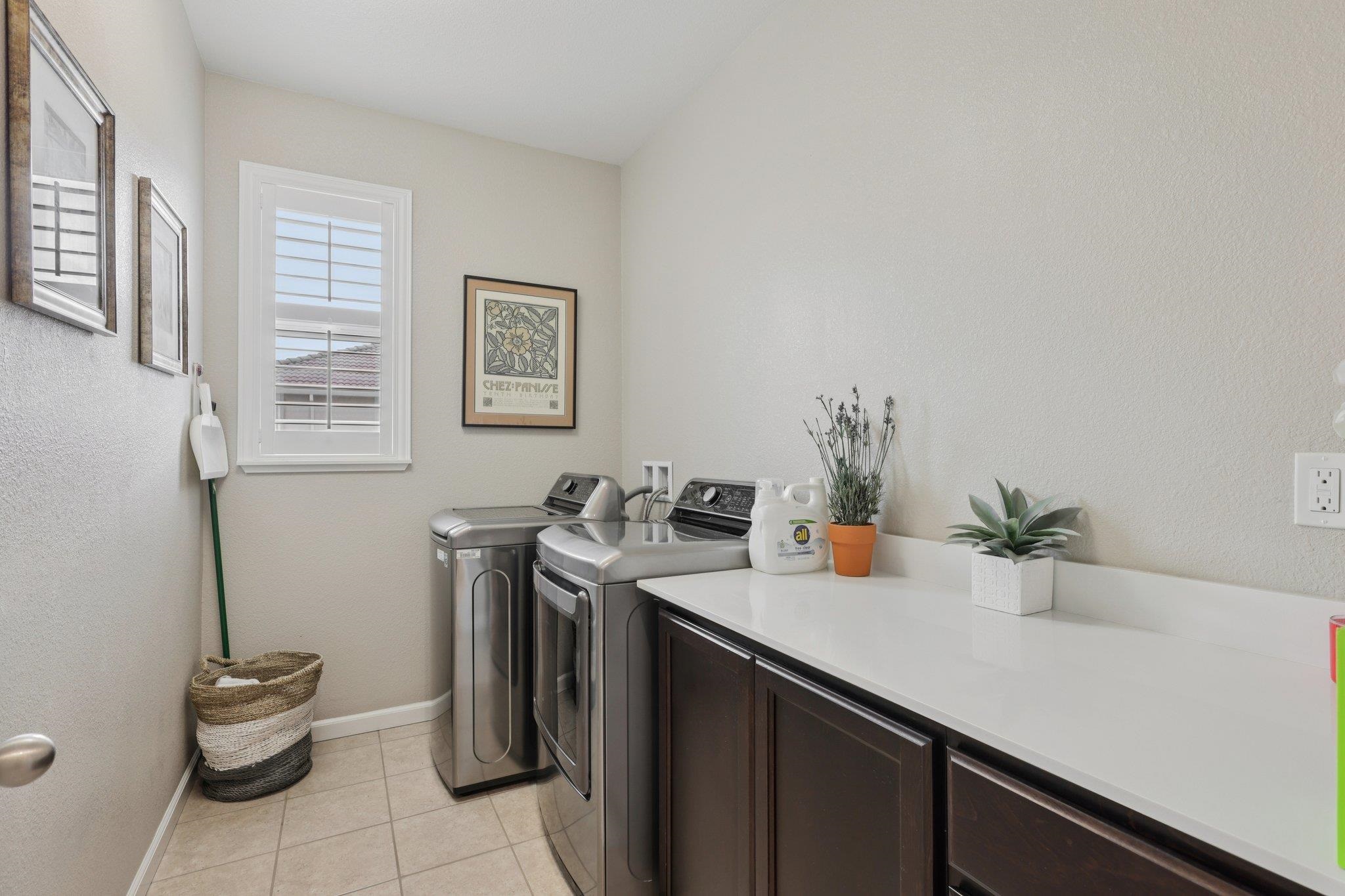 165 Little Ranch Circle Oakley, CA 94561 - Photo 28 of 60 Laundry room with light tile patterned floors, independent washer and dryer, cabinet space, and a textured wall