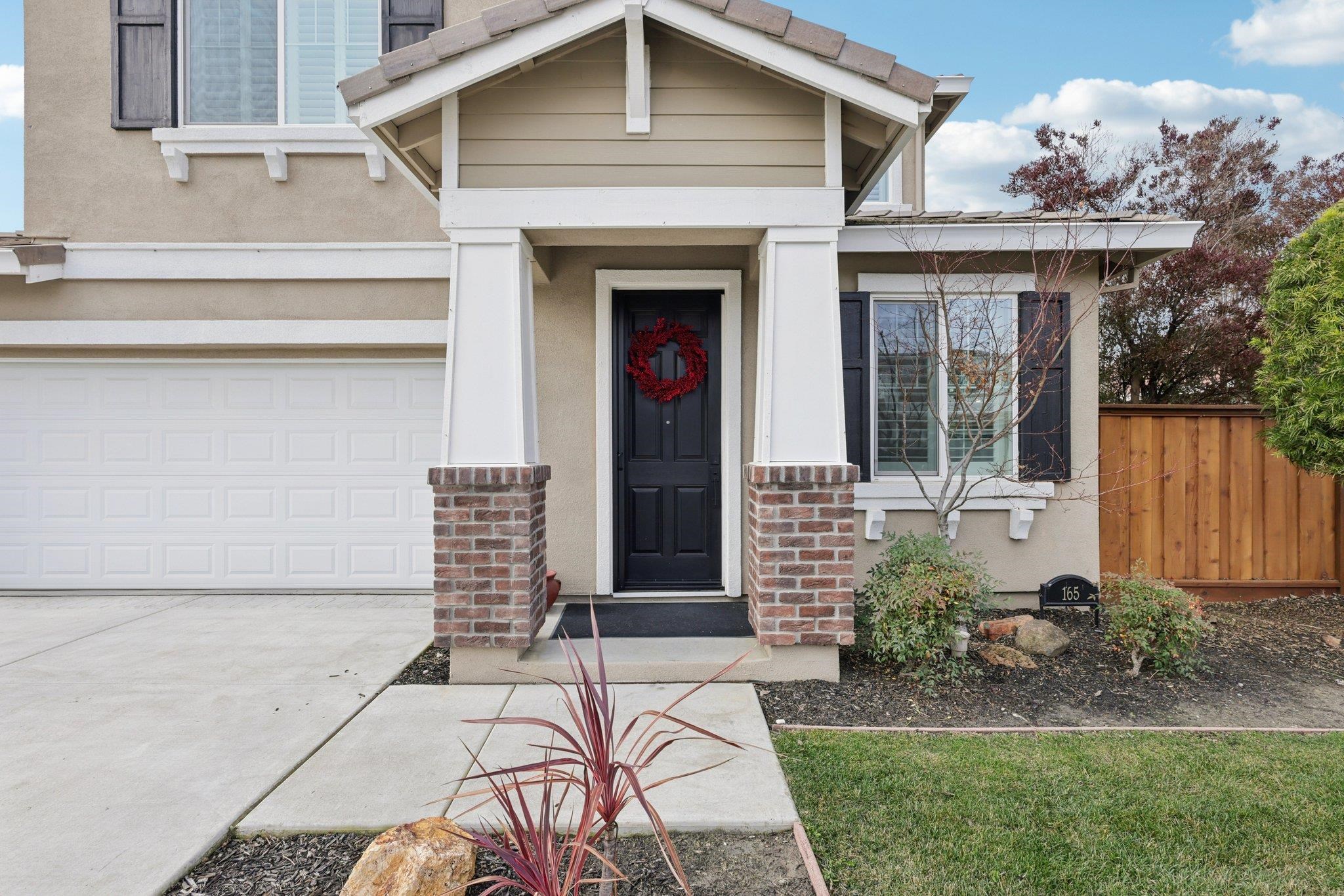 165 Little Ranch Circle Oakley, CA 94561 - Photo 5 of 60 View of exterior entry with brick siding, concrete driveway, and stucco siding