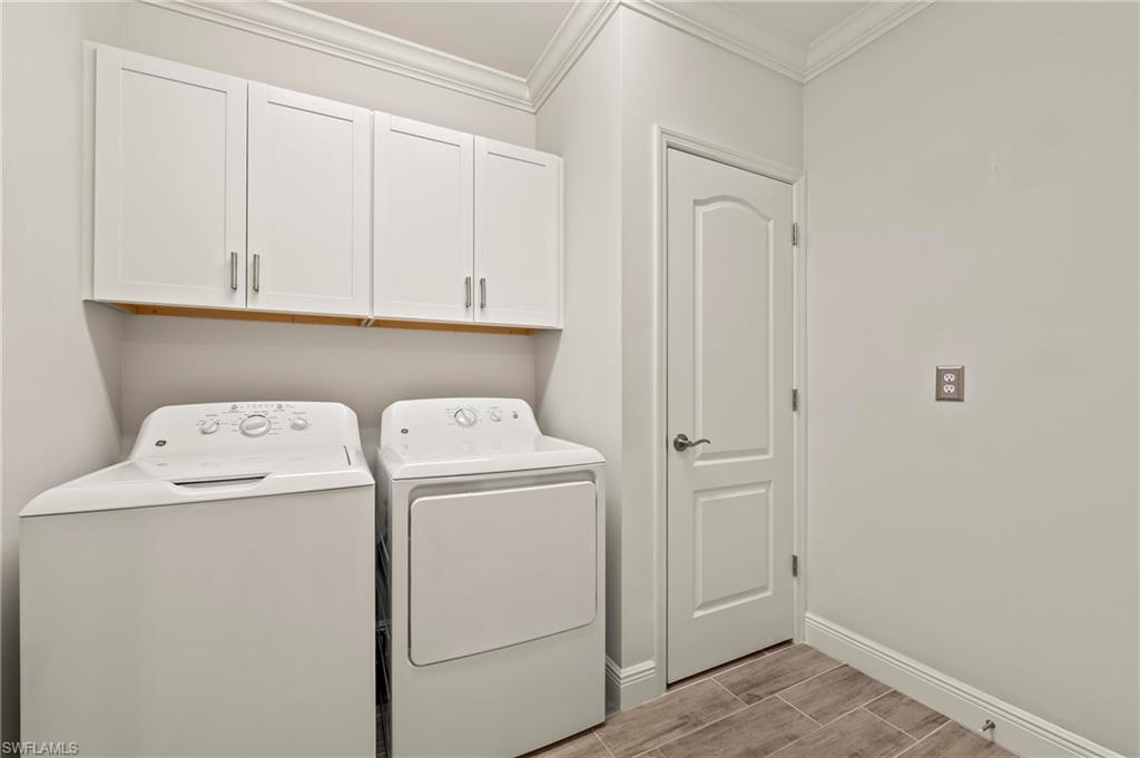 6954 Avalon Circle, Unit 703 Naples, FL 34112 - Photo 11 of 17 a view of storage and utility room with washer and dryer