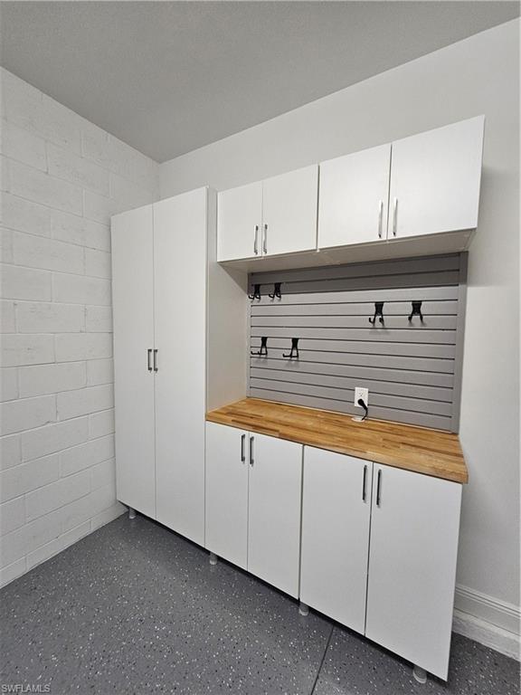 6954 Avalon Circle, Unit 703 Naples, FL 34112 - Photo 14 of 17 a view of kitchen with granite countertop cabinets