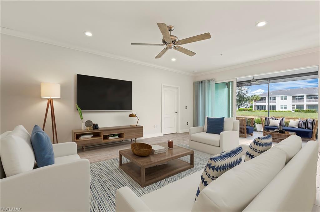 6954 Avalon Circle, Unit 703 Naples, FL 34112 - Photo 2 of 17 a living room with furniture and a flat screen tv