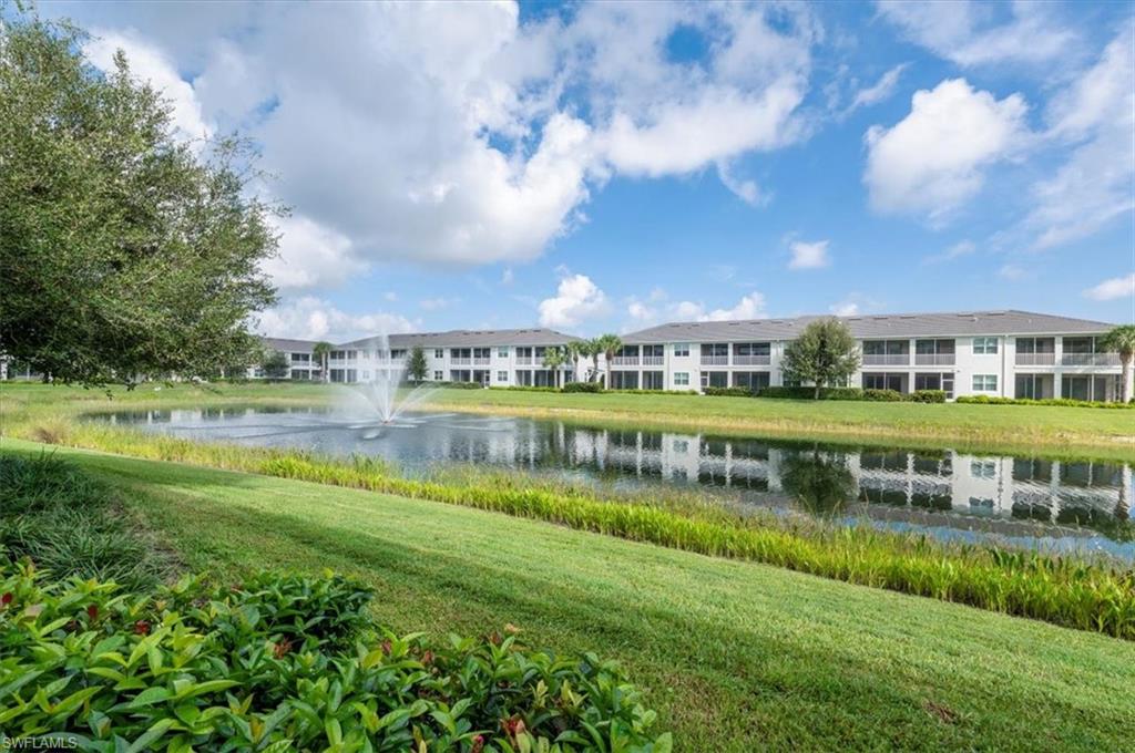 6954 Avalon Circle, Unit 703 Naples, FL 34112 - Photo 10 of 17 a view of a big yard with plants and large trees