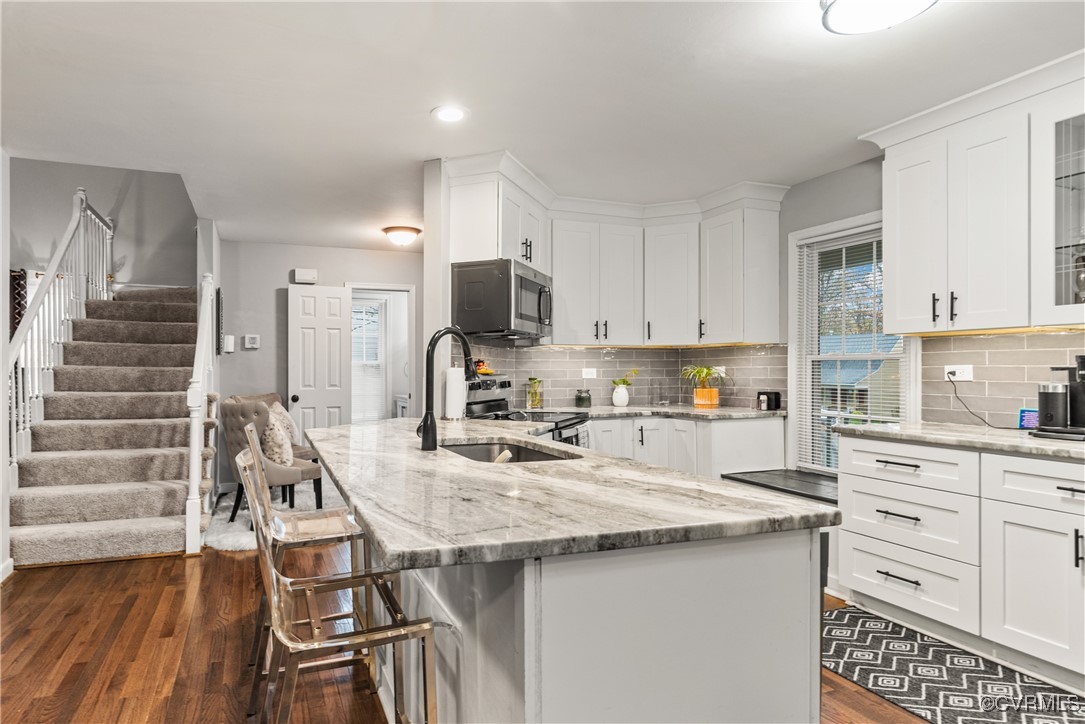 7106 Pointer Ridge Road Midlothian, VA 23112 - Photo 13 of 49 a kitchen with kitchen island a stove a sink and a refrigerator