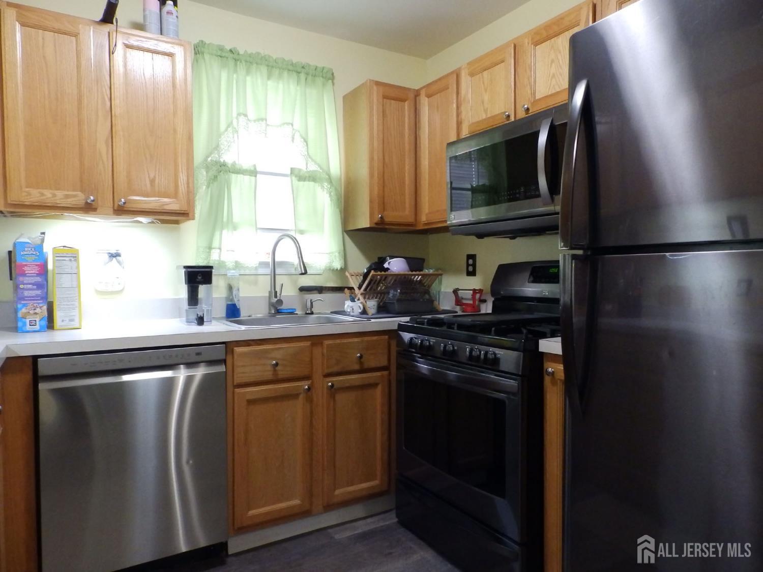 508 Cypress Lane East Brunswick, NJ 08816 - Photo 4 of 15 a kitchen with stainless steel appliances white cabinets and a sink