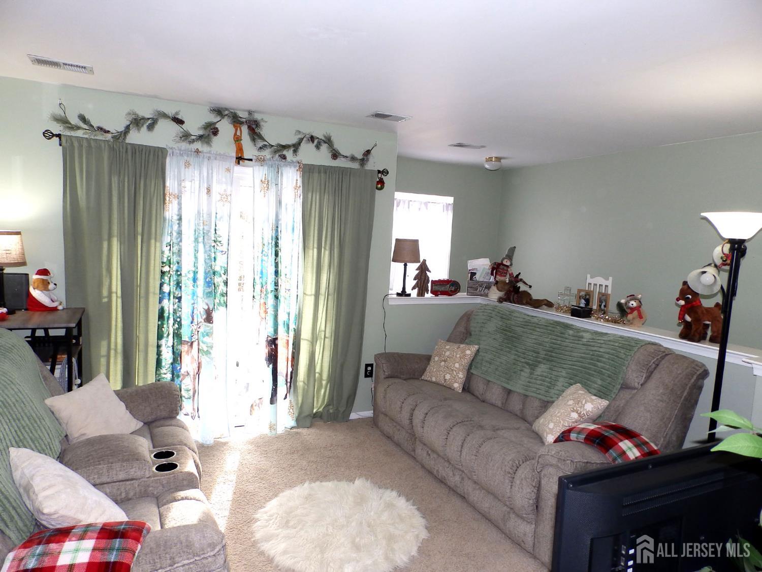 508 Cypress Lane East Brunswick, NJ 08816 - Photo 7 of 15 a living room with furniture and a chandelier