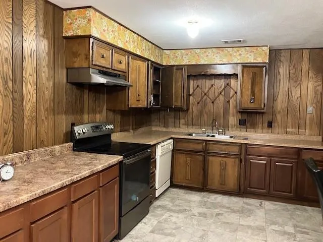 a kitchen with stainless steel appliances granite countertop a sink stove and cabinets