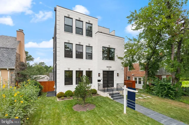 a view of a hallway with wooden floor and a cabinet