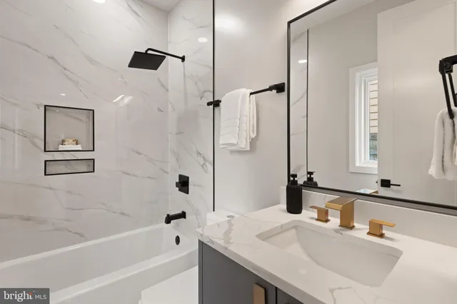 a kitchen with stainless steel appliances granite countertop a sink and wooden cabinets with wooden floors