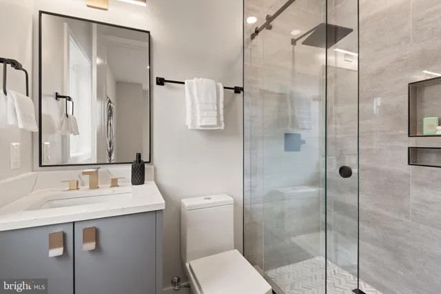 a bathroom with a bathtub a mirror and a shower