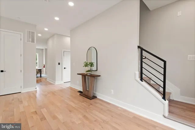 a living room with fireplace furniture and floor to ceiling windows