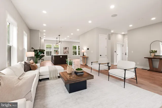 a large kitchen with lots of counter space and a wooden floor