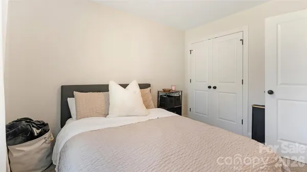 a bedroom with a bed and a lamp