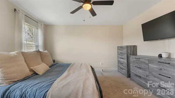 a bedroom with a bed and flat screen tv