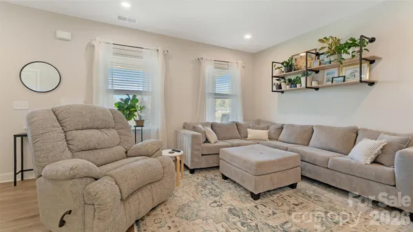 a living room with furniture kitchen and a window