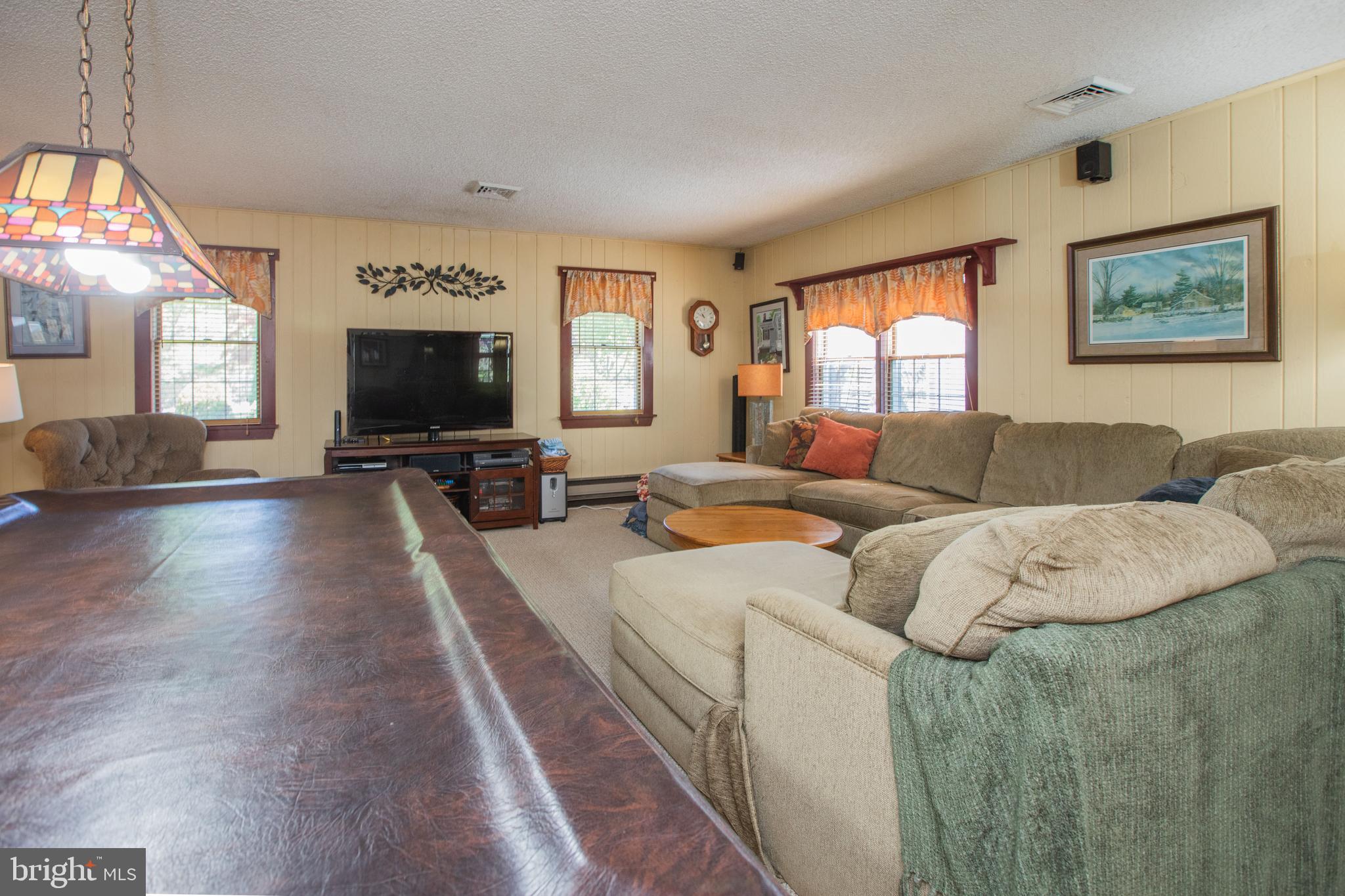 12 Millstream Road Cream Ridge, NJ 08514 - Photo 13 of 76 a living room with furniture and a flat screen tv