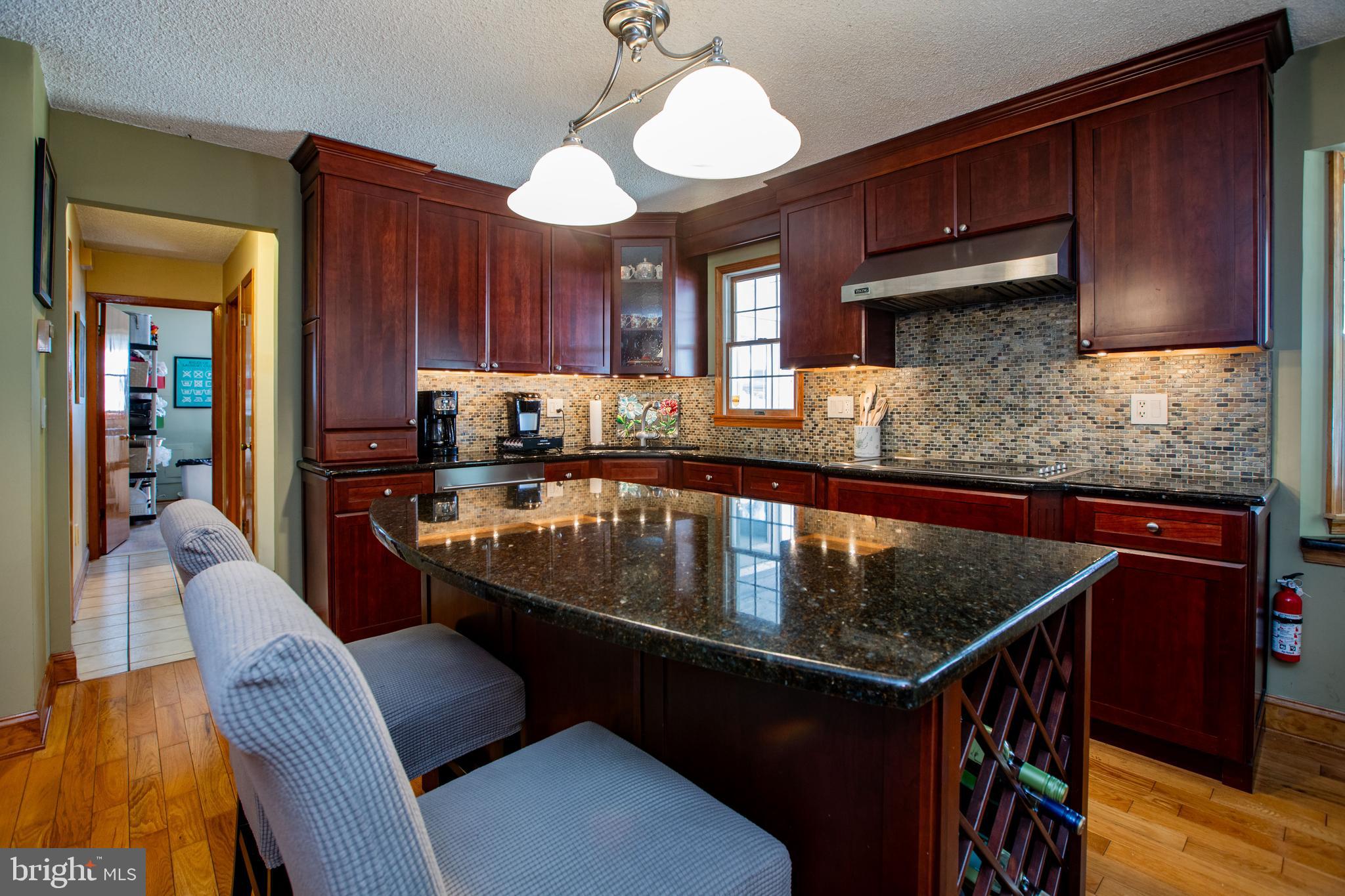 12 Millstream Road Cream Ridge, NJ 08514 - Photo 21 of 76 a kitchen with stainless steel appliances granite countertop a sink a stove top oven a dining table and chairs