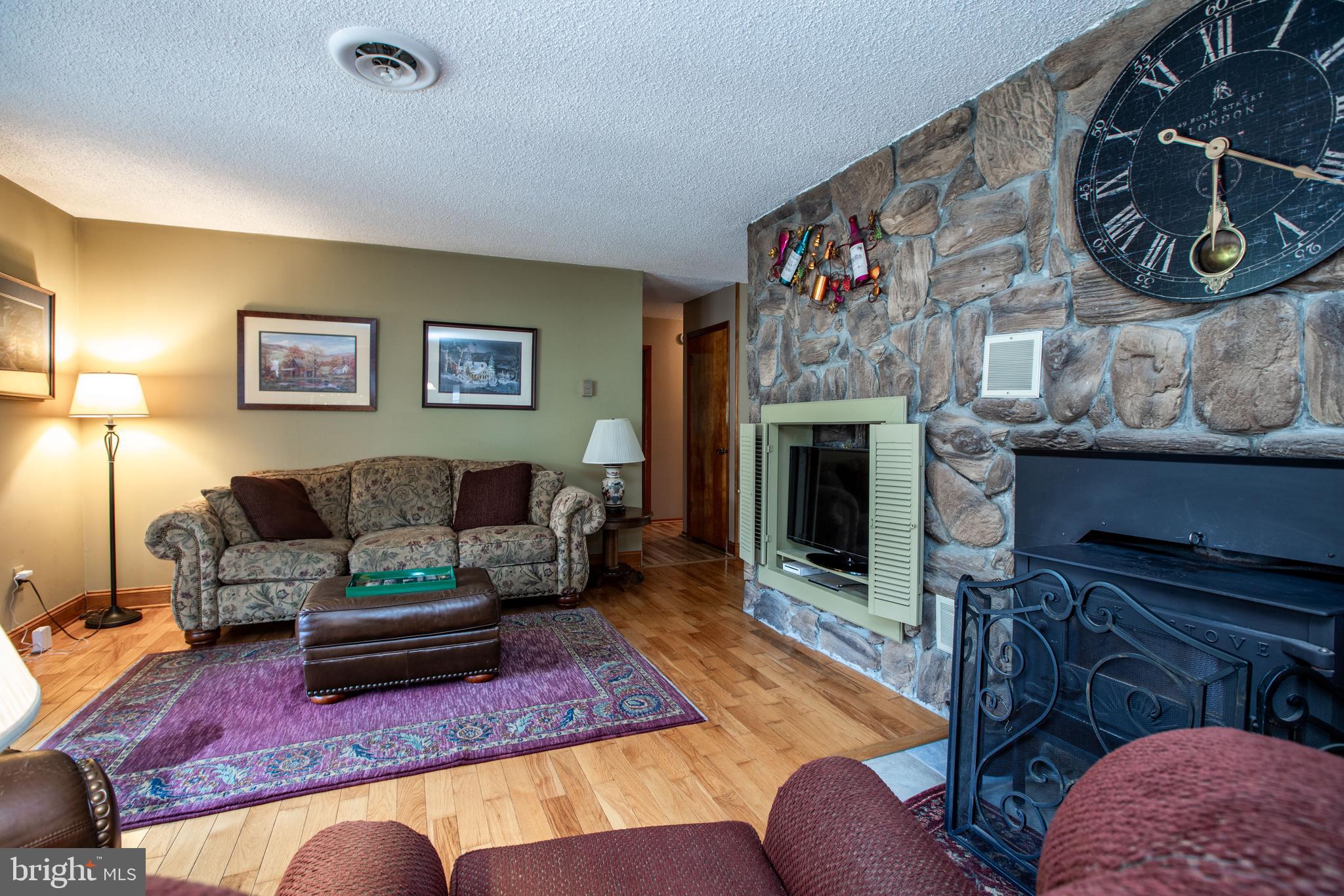 12 Millstream Road Cream Ridge, NJ 08514 - Photo 27 of 76 a living room with furniture and a fireplace