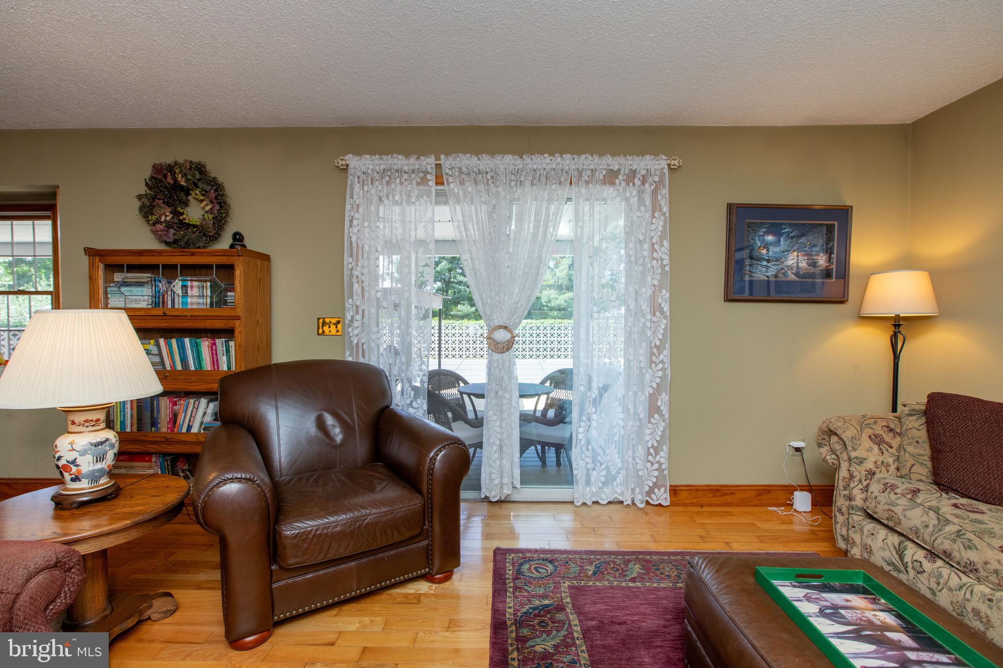 12 Millstream Road Cream Ridge, NJ 08514 - Photo 29 of 76 a living room with furniture and a lamp