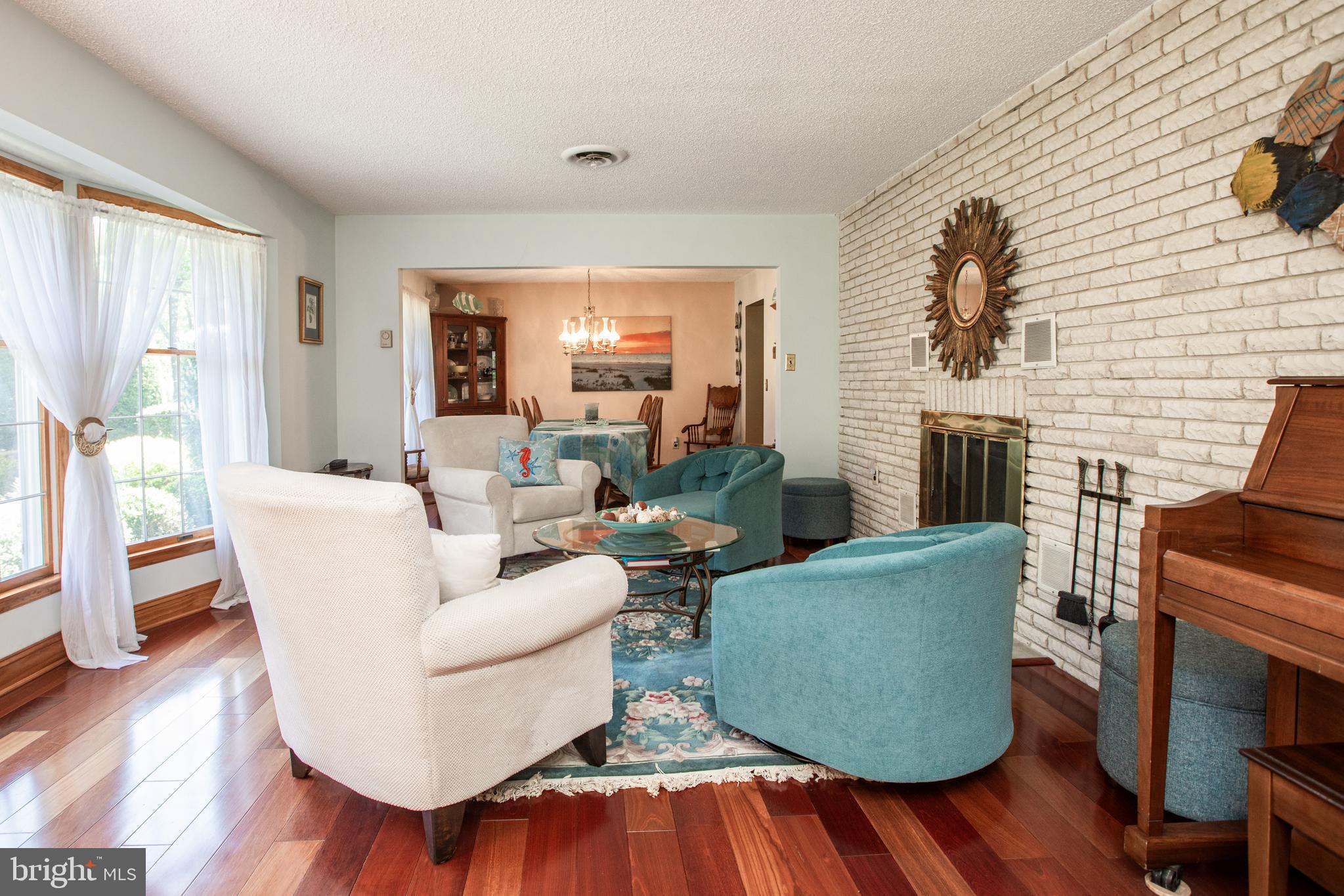 12 Millstream Road Cream Ridge, NJ 08514 - Photo 32 of 76 a living room with fireplace furniture and a wooden floor