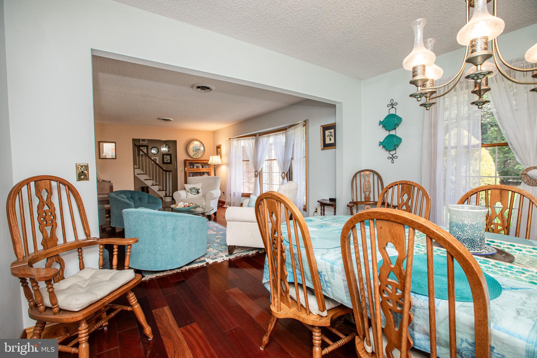 12 Millstream Road Cream Ridge, NJ 08514 - Photo 35 of 76 a view of a dining room with furniture a chandelier and wooden floor