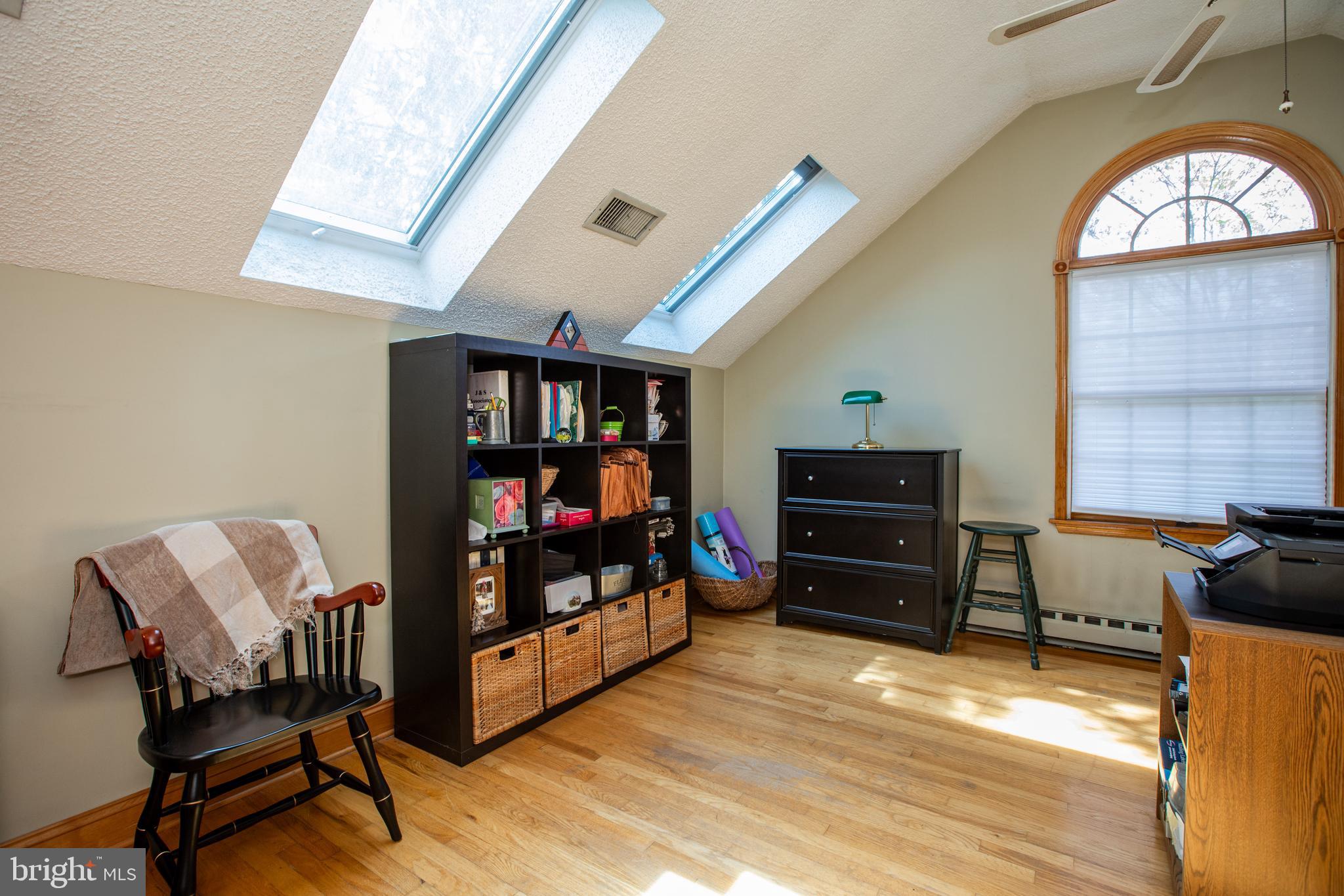 12 Millstream Road Cream Ridge, NJ 08514 - Photo 37 of 76 a living room with furniture a flat screen tv and a fireplace