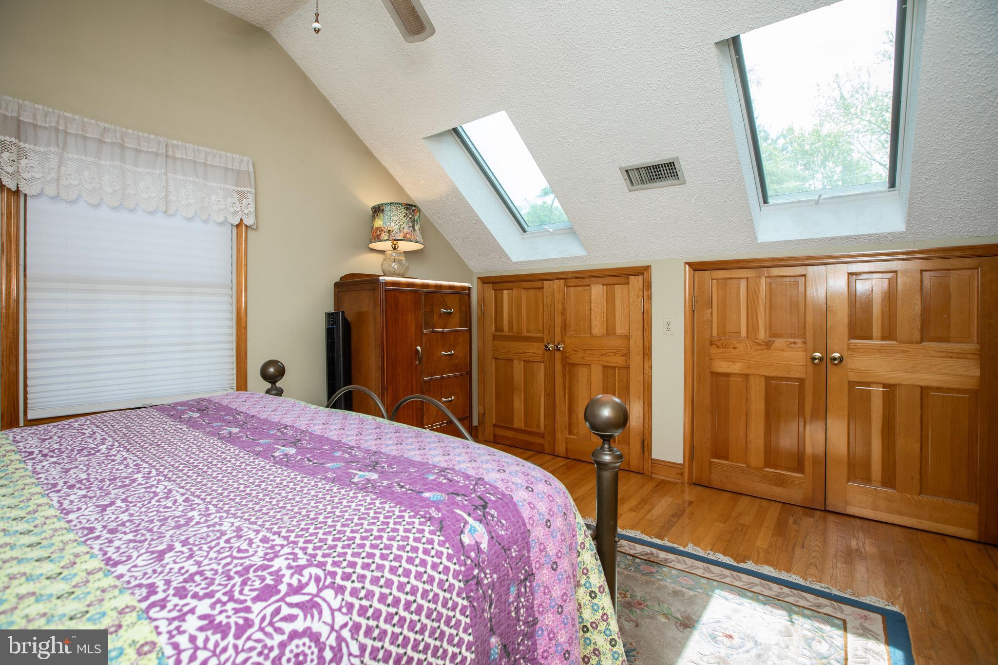 12 Millstream Road Cream Ridge, NJ 08514 - Photo 40 of 76 a bedroom with a large bed and a chandelier