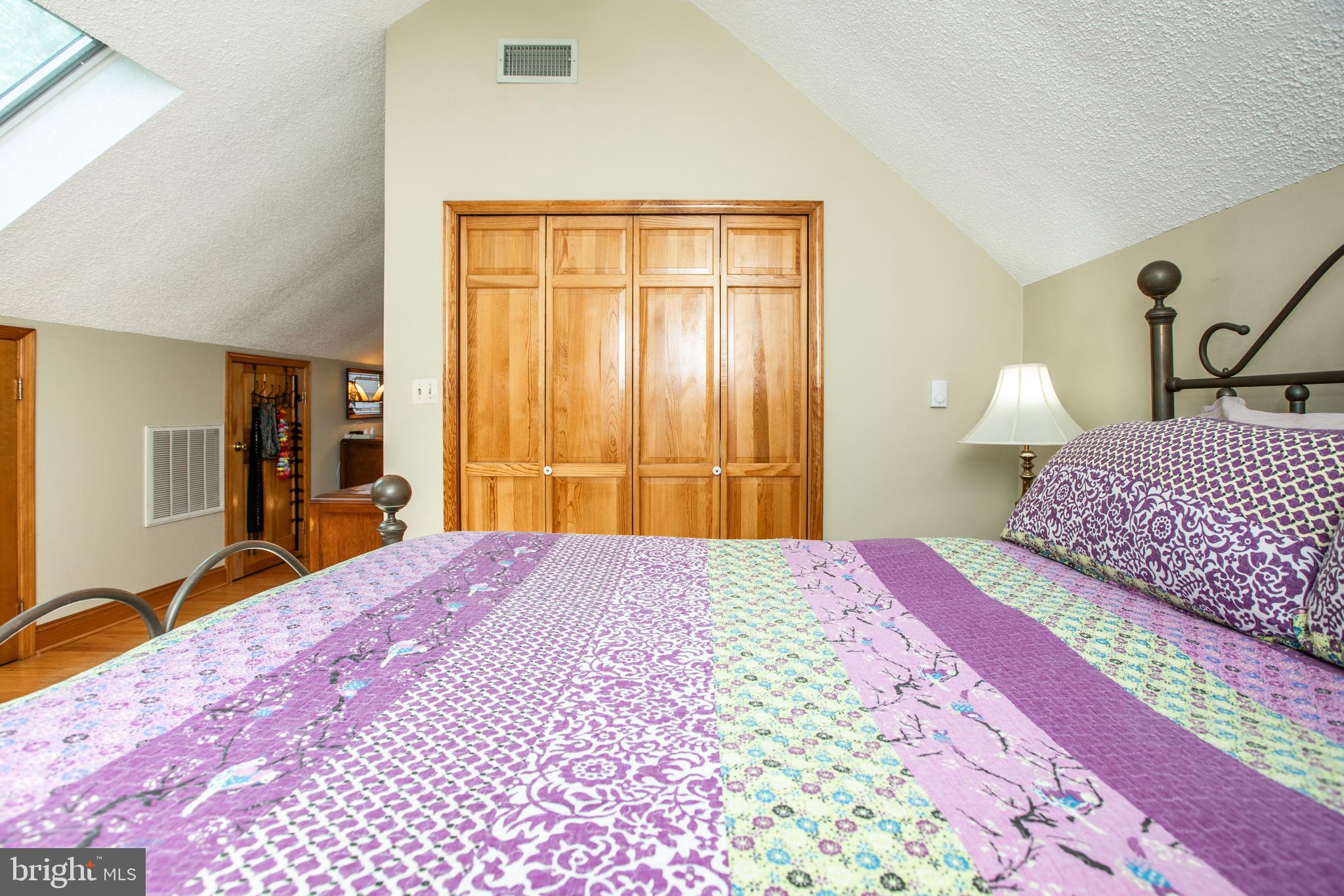 12 Millstream Road Cream Ridge, NJ 08514 - Photo 41 of 76 a bedroom with a bed and wooden floor