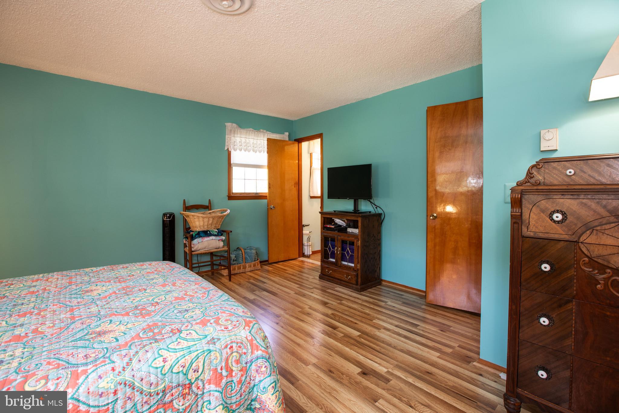12 Millstream Road Cream Ridge, NJ 08514 - Photo 49 of 76 a bedroom with a bed and a television in it